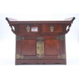 A Chinese elm and brass mounted table top cabinet, width 35cm