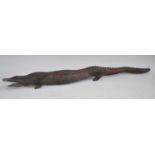 A large carved native African hardwood figure of a crocodile, signed to the underside David