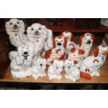 A collection of 19th century and later Staffordshire spaniels (10)One with red spots facing right is