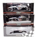 A Minichamps Maclaren Collection 1/18 scale boxed diecast group, three examples to include a David