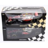 A Minichamps Vodafone Maclaren Mercedes 1/18 scale boxed diecast group to include a Lewis Hamilton