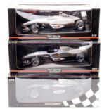 A Minichamps Maclaren Collection 1/18 scale boxes F1 race car group, to include a David Coulthard