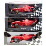 A Minichamps/Pauls Model Art 1/18 scale boxed Ferrari F1 race car group to include an E Irvine