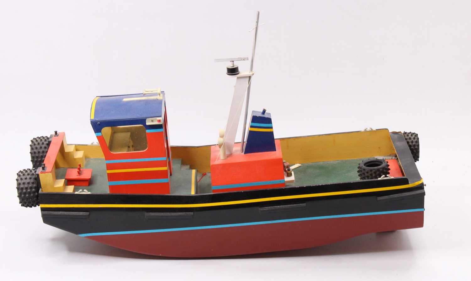A wooden scratch built model of a radio controlled pusher tug, hand painted example with removable