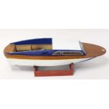 A wooden and GRP hulled kit built model of a cabin cruiser boat, comprising of white GRP hull with