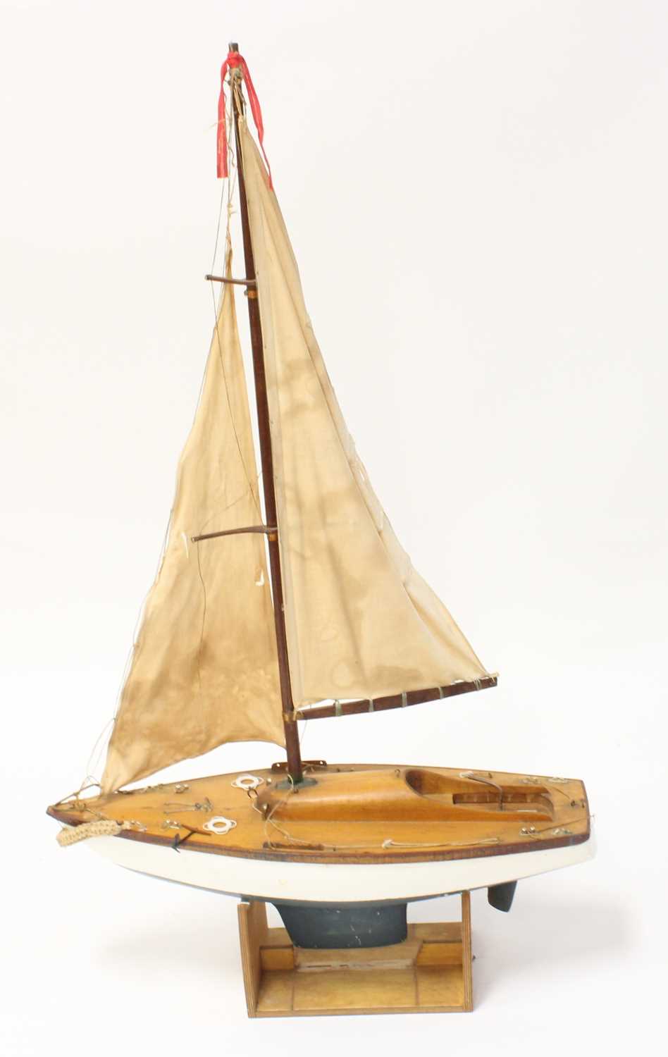 A kit built model of a wooden and GRP hulled pond yacht comprising of white hull with lead