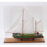 A very well made wooden static display model of a Sam One Ipswich sailing boat housed in a perspex