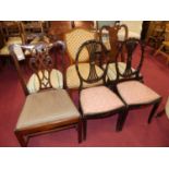 A pair of Edwardian black painted Heppelwhite style salon chairs; together with a single mahogany