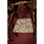 A 19th century mahogany Chippendale style elbow chair, having a floral needlework drop-in pad