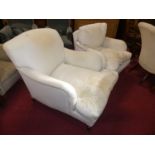 A Howard style plain upholstered easy armchair, raised on tapering supports to brass castors, w.