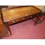 A circa 1900 mahogany two-drawer writing table, having a three-quarter raised gallery, on turned