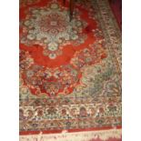 A large Persian style machine woven red ground Keshan Super rug, 350 x 250cm