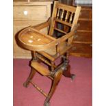 An early 20th century beech child's high chair