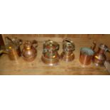 A collection of six copper and brass jugs etc