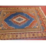 A Persian woollen blue ground Shiraz rug, having trailing tramline borders, 265 x 180cm