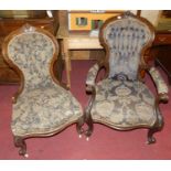 A pair of Victorian carved and stained walnut lady's and gent's parlour chairs, each with floral