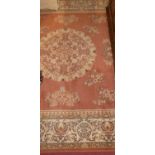 A Chinese style pink ground machine woven rug, 300 x 200cm