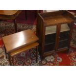 A 1930s small oak double door glazed low bookcase; together with a mahogany nest of two occasional