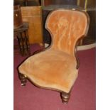 A mid-Victorian mahogany framed and velour fabric buttoned upholstered nursing chair, on turned
