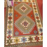 A Turkish woollen rug, having a floral geometric ground within trailing borders, 215 x 148cm