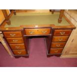 An Edwardian mahogany and inlaid green rexine inset inverted breakfront kneehole writing desk, w.