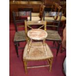 A pair of circa 1900 black painted and floral decorated rush seat bedroom chairs; together with a