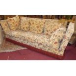 A floral needlework fabric upholstered three-seater Knole settee, with sundry cushions, w.240cm