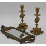 A pair of 19th century brass table candlesticks, h.23cm; together with a brass wall mirror, 43 x