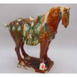 A Chinese Tang style sancai glazed earthenware mode of a horse, h.43cm