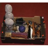 A box of miscellaneous items, to include wooden carvings and pipes