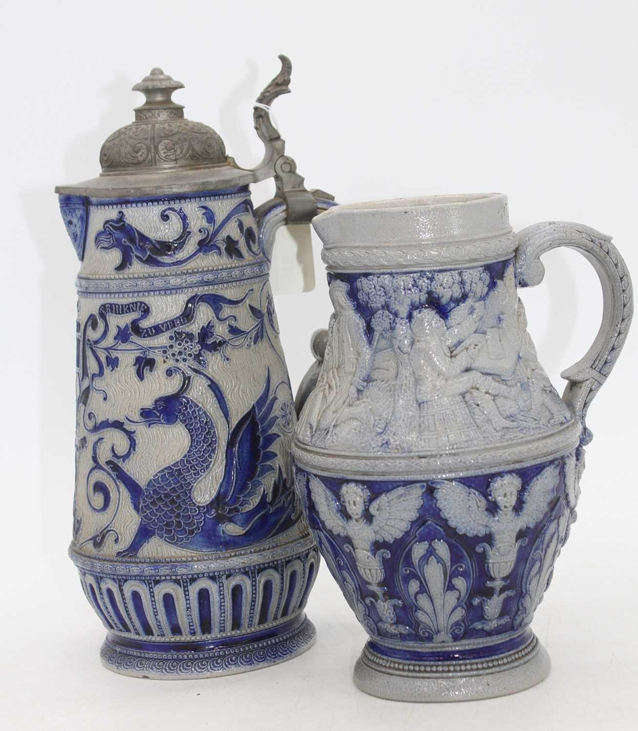 Two Rhineland stoneware jugs, each decorated with mythical creatures, the largest h.31cm