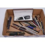 A cased Cross Dubai fountain pen and ballpoint pen set, in black with chrome trim; and a tray of