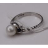 A contemporary white metal, cultured pearl, sapphire and diamond point set dress ring, stamped