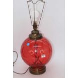 A 20th century red glass table lamp, of globular form, h.57cm (including fittings)57cm to the wire
