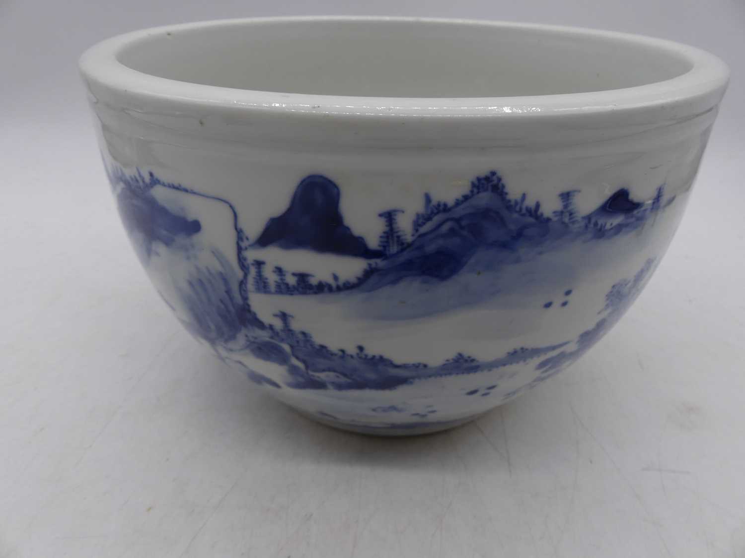 A Chinese blue and white stoneware jardiniere, decorated with a mountain landscape, h. - Bild 8 aus 10