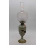 A Victorian green glass oil lamp, the acid etched shade above a floral decorated body, h.55cm