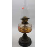 A Victorian oil lamp, having amber glass font, h.54cm