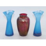 An iridescent glass vase, h.16cm; together with a pair of blue glass vases, h.18cm