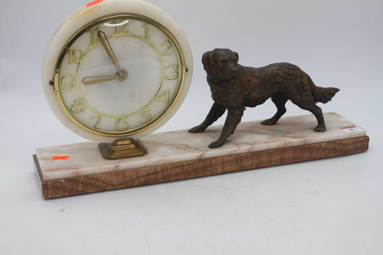 An Art Deco polished hardstone mantel clock, surmounted by a spelter model of a dog, w.50cm - Bild 2 aus 2