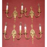 A set of four 20th century brass neoclassical style twin branch wall sconces