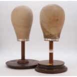 A near pair of mid-20th century canvas covered milliners hat stands, each on an oak column and beech