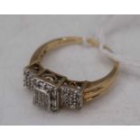 A modern 9ct gold and diamond set dress ring, arranged as small cut alternating brilliants and