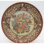 A Japanese satsuma plate, decorated with a bird amongst flowers, dia.30cm