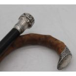 A Victorian ebonised walking stick, having silver handle, 84cm; together with one other (2)