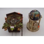 A 20th century Swiss cuckoo clock, h.31cm; together with a clock in the form of a globe, h.23cm (2)