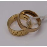 An 18ct gold wedding band, having textured decoration, 5.4g, size K; together with a 9ct gold