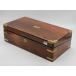 A Victorian rosewood writing slope, the id lifting to reveal a black leather lined writing