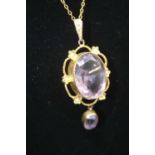 An early 20th century 9ct gold, amethyst and seed pearl set pendant, in ropetwist mount, 44mm (