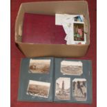 A large collection of vintage postcards, many housed in albums