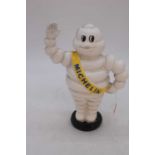 A reproduction cast iron money-box in the form of the Michelin Man, h.23cm